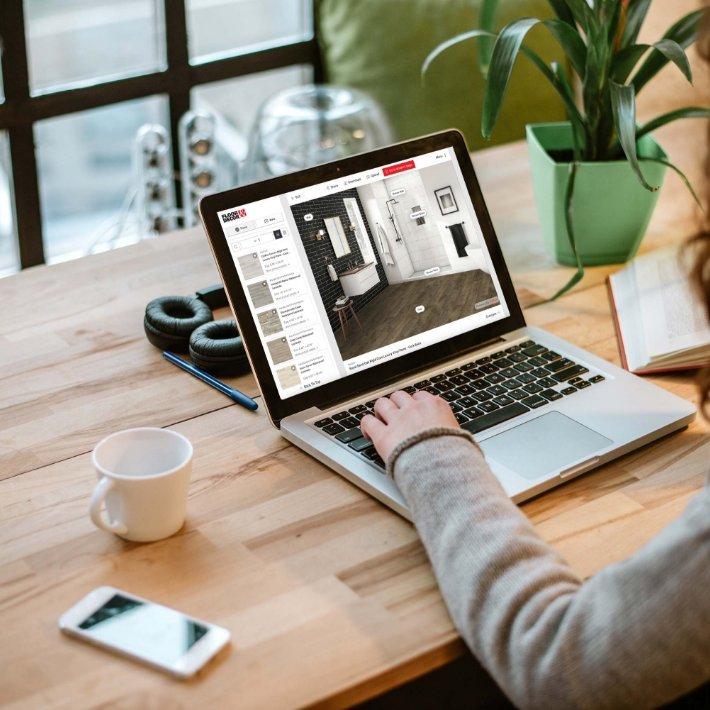Person viewing laptop screen with vinyl product in visualizer tool